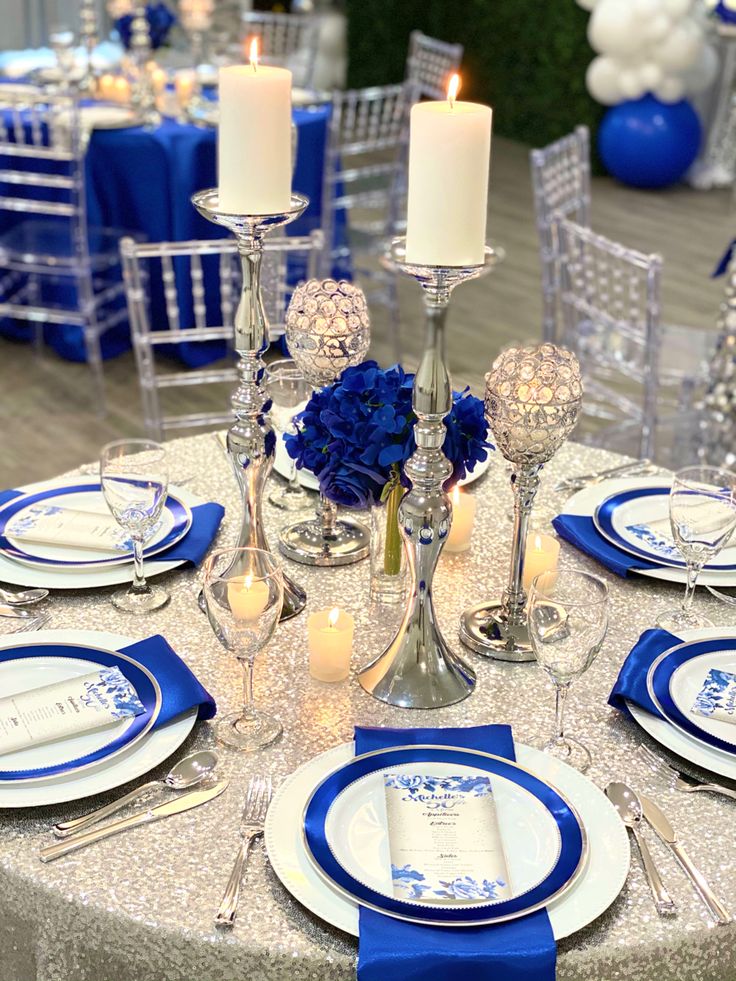 the table is set with blue and white place settings