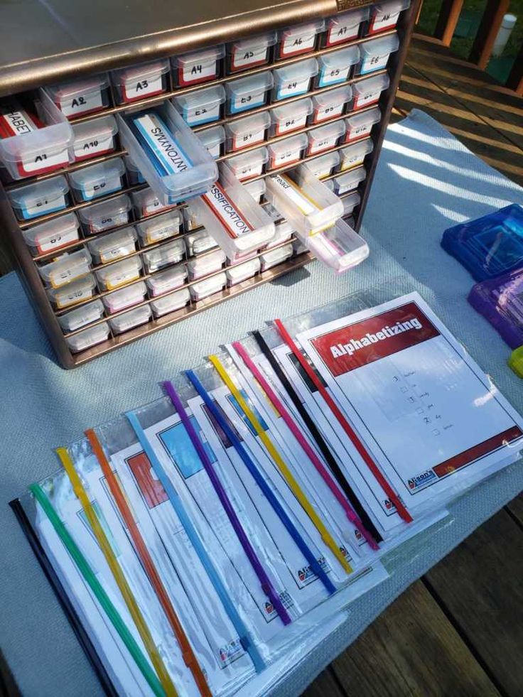 several stacks of books on a table with papers and pencils in front of them