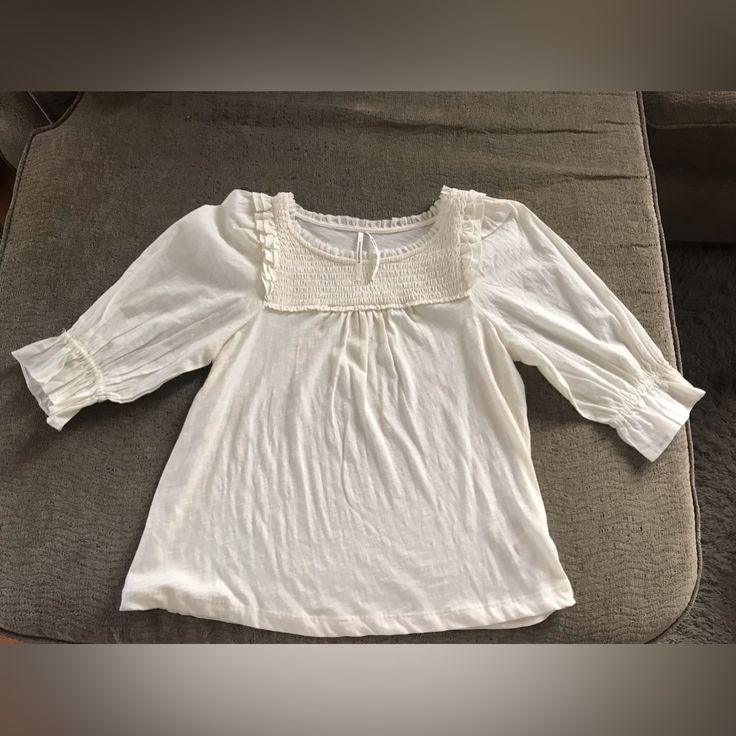 The Cutest And Lightweight Ivory Lightweight Top With 3:4 Sleeves From Anthropologie. Size Xs. Never Worn But No Tags Attached. Originally Paid $68. Selling For $15. White Smocked Bodice Top For Spring, White Peasant Top With Smocked Bodice For Day Out, White Smocked Bodice Peasant Top For Day Out, White Smocked Top With Smocked Back For Day Out, White Smocked Back Top For Day Out, White Tops With Smocked Cuffs For Day Out, Cream Tops With Smocked Cuffs For Spring, White Smocked Bodice Top With Short Sleeves, Summer White Blouse With Smocked Bodice