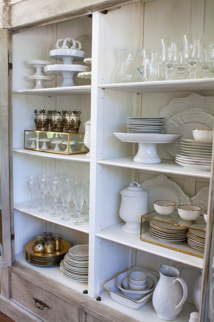 an old china cabinet is filled with dishes