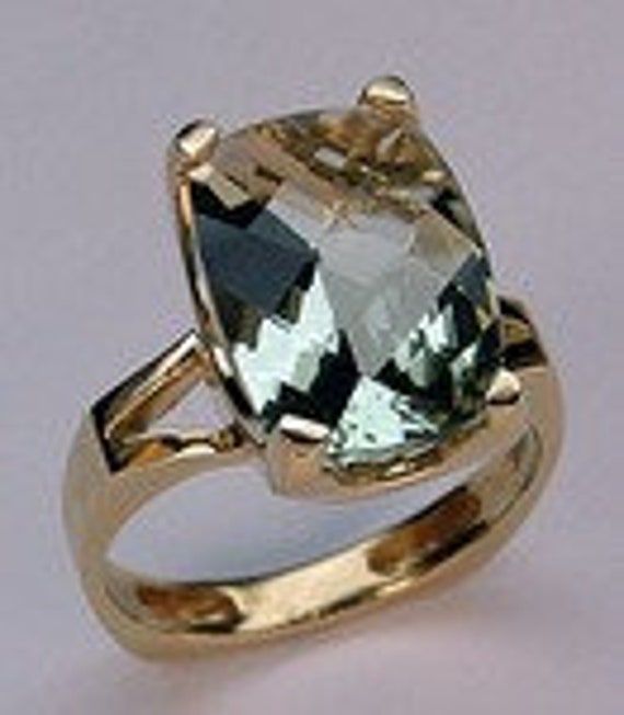 This 14k yellow gold ring has a beautiful 5.80ct green amethyst gemstone as its main attraction.  Show off this green amethyst cocktail ring on your next night out.   SKU: EGR525       Item:  5.80ct Green Amethyst Yellow Gold Ring Gold: 14kt Yellow Gold Stone Weight: 5.80ct Green Amethyst  Length: 3/4" Green Amethyst Ring For Formal Occasions, Elegant Green Oval Amethyst Ring, Elegant Gold Ring With Green Amethyst, Formal Green Amethyst Ring With Accent Stones, Elegant Gold Rings With Green Amethyst, Luxury Green Amethyst Ring With Accent Stones, Formal Gold Amethyst Ring With Green Stone, Formal Green Amethyst Ring In Gold, Formal Gold Rings With Green Amethyst