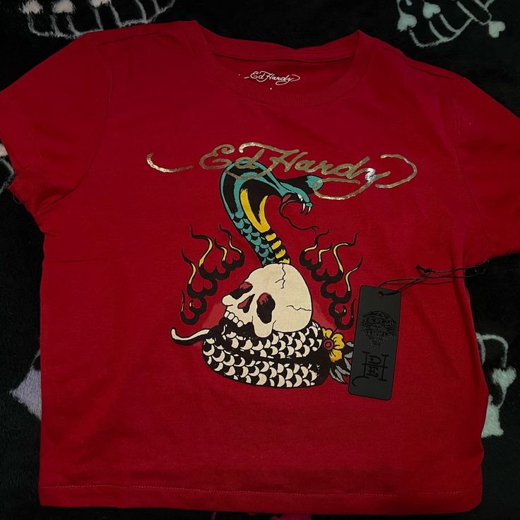 Dark Red Ed Hardy Crop Top Shirt.. It’s Not A Bright Red My Camera Couldn’t Accurately Show The Color. Brand New With Tags Never Worn Size Medium Edgy Red Cotton Tops, Edgy Red Summer Tops, Trendy Red Streetwear Shirt, Trendy Fitted Red Shirt, Fitted Red Top In Edgy Style, Edgy Red Top With Graphic Print, Edgy Red Summer Top, Red Cotton Edgy Tops, Red Edgy Cotton Tops