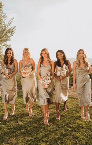 the bridesmaids are all dressed in tan dresses