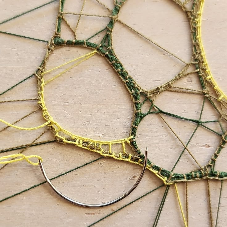 there are several pieces of yarn that have been woven together to make a wall hanging