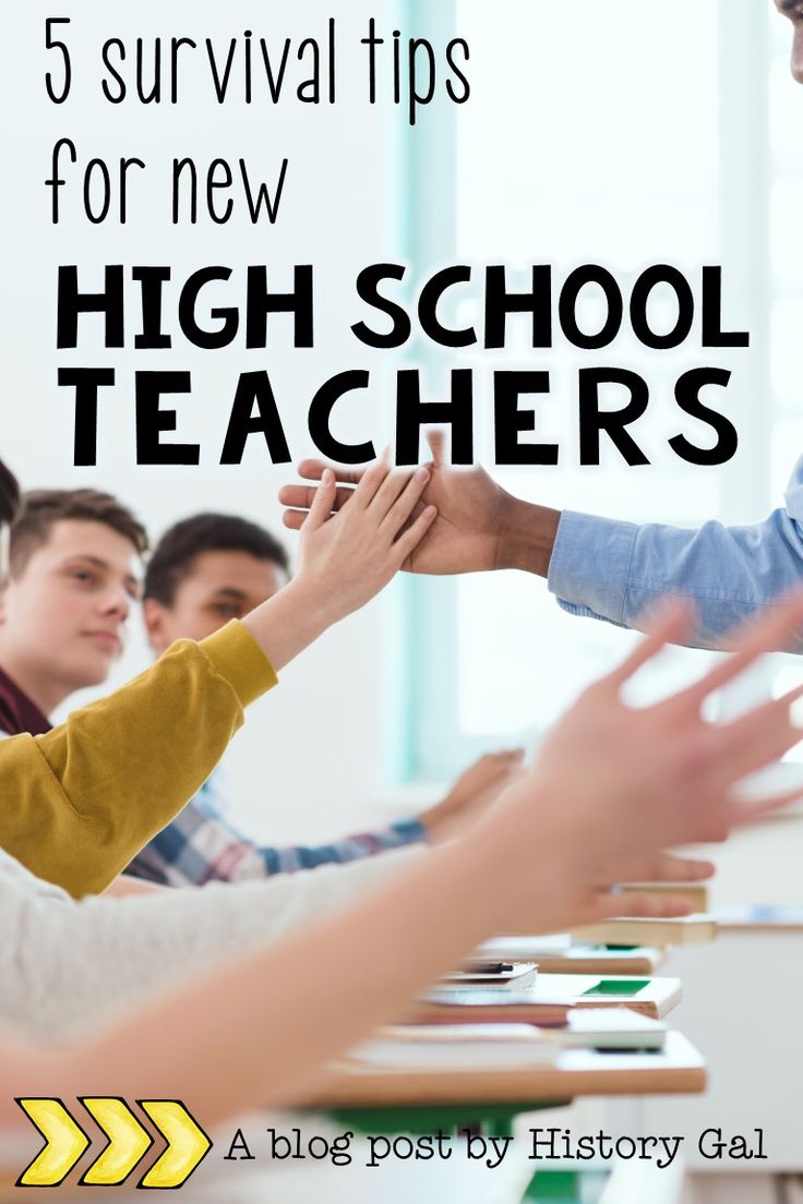 five students sitting at a table with their hands together