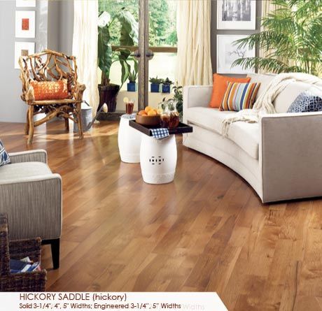 a living room filled with furniture and lots of wood flooring on top of a hard wood floor