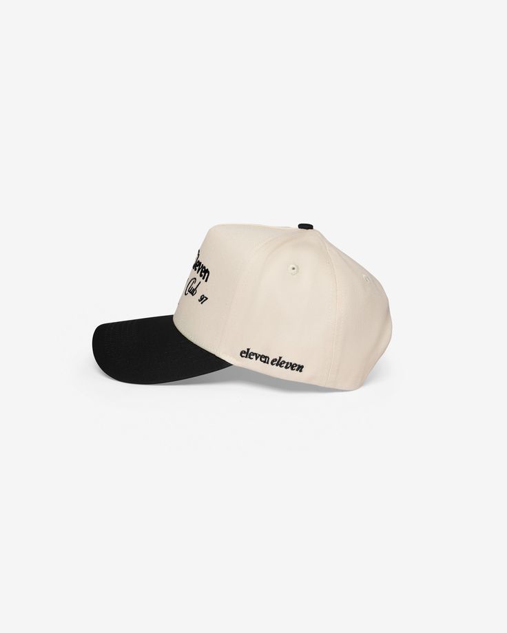 a white and black baseball cap with the words,