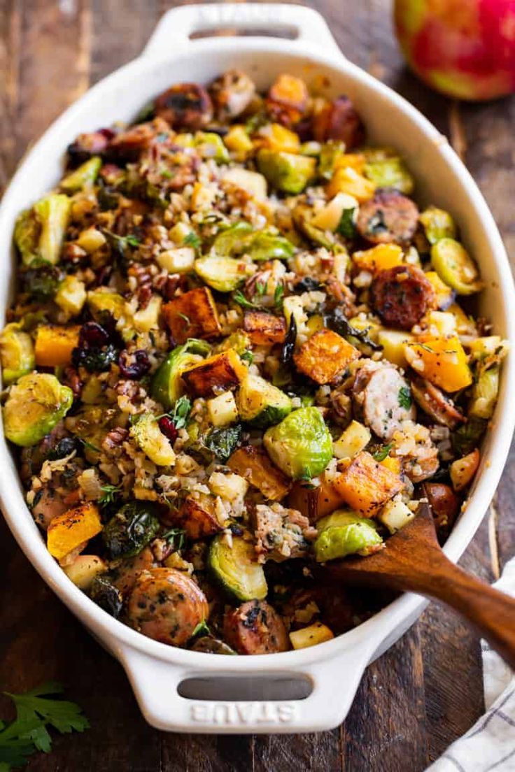 a white bowl filled with stuffing and vegetables