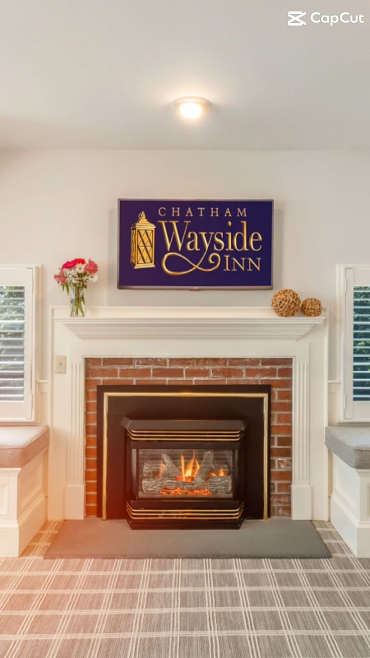 a fireplace with a sign above it that says chatham wayside inn on the wall