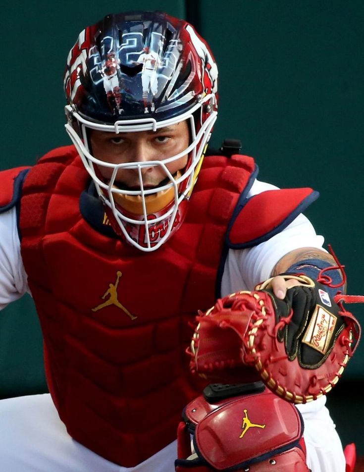 a baseball player wearing a catchers mitt and holding a glove in his hand