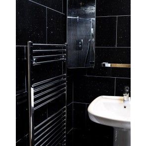 a bathroom with black tiles and a white sink