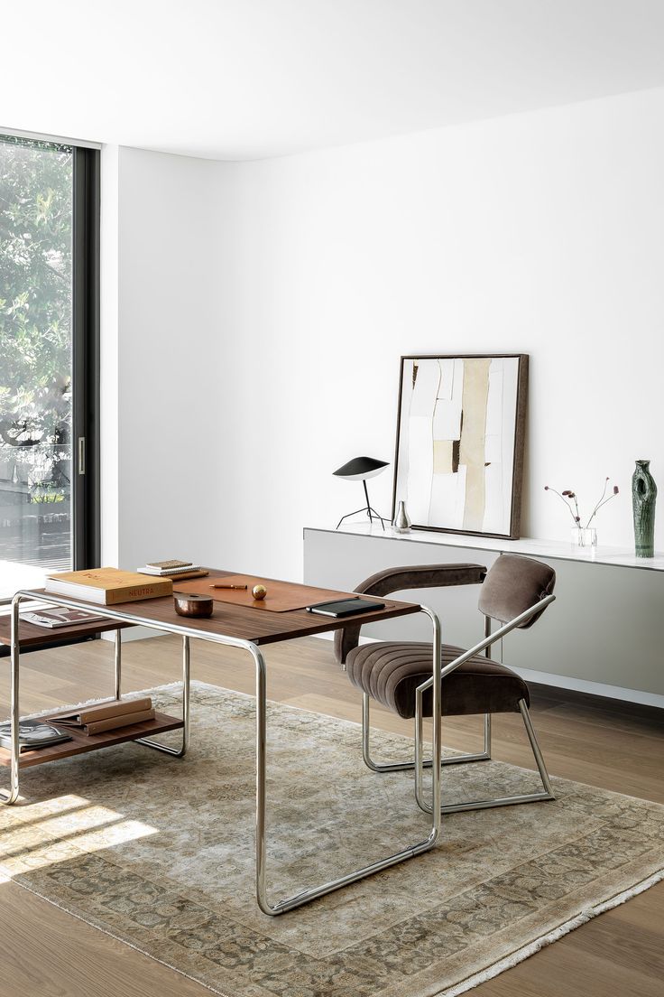 A designer desk in the home office with a stylish armchair and pure silk rug. Behind on a console is a neutral artwork and small sculptural homewares. Designer Desk Workspaces, Vintage Office Desk, Office With A View, Vintage Office Chair, Design Studio Office, Homes To Love, Contemporary Home Office, Desk And Chair, Desk In Living Room