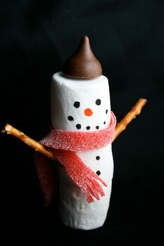 a marshmallow snowman with a red scarf around it's neck and nose