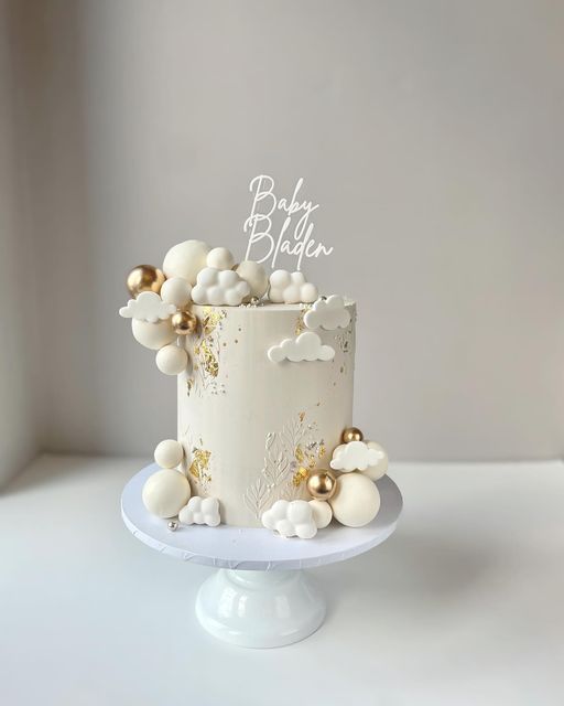 a white cake with gold decorations on top