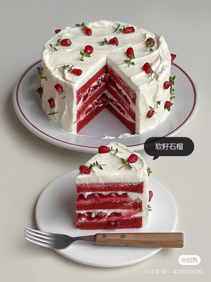 two slices of red velvet cake with white frosting and strawberries on each slice