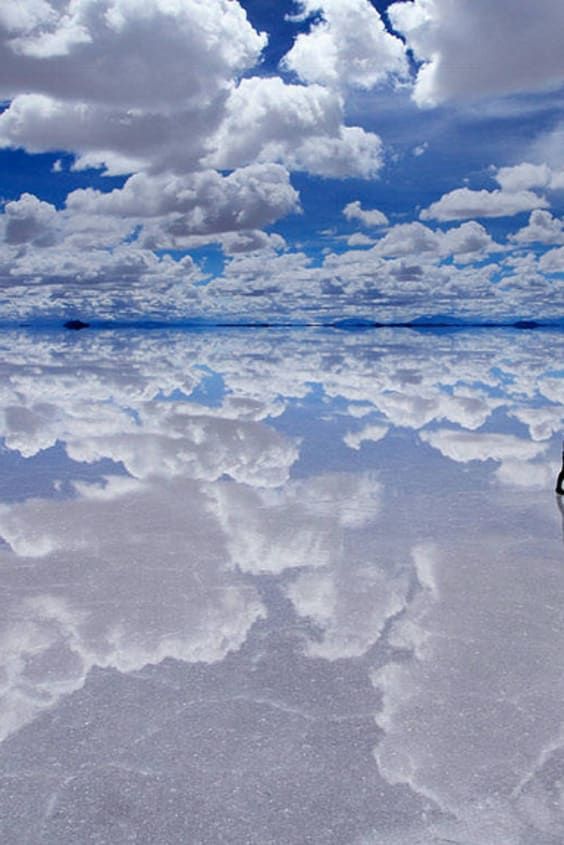 the reflection of clouds in the water is very clear and blue with no one on it