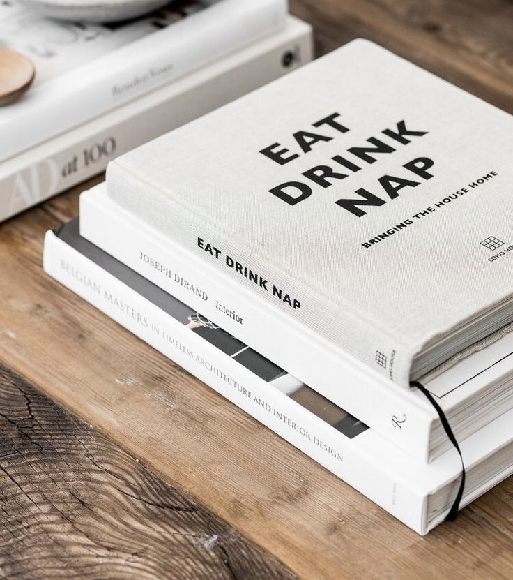 two books are stacked on top of each other, with the title eat drink map