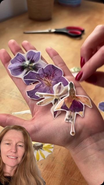 a woman is holding out her hand with flowers on it