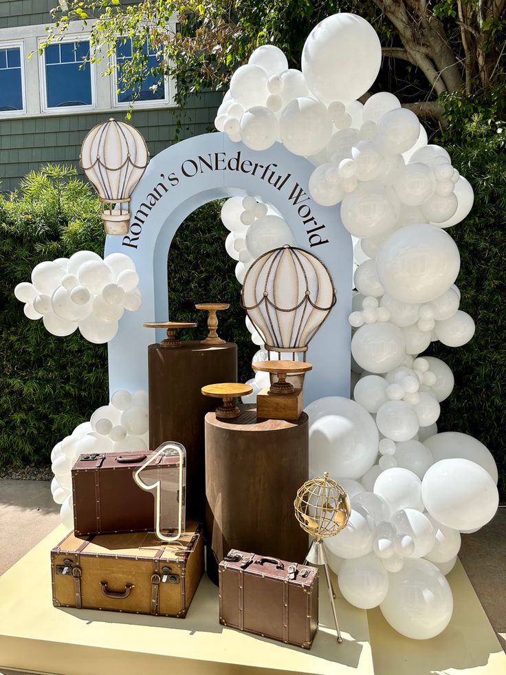 balloons and suitcases are on display at an outdoor event