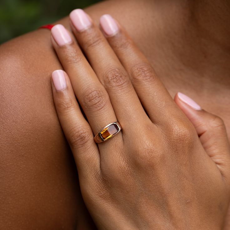 The Story A chic and classic Victorian era ring set with a beautiful citrine sitting front and center. Constructed from 14k rose gold, the long faceted stone measures 12.2 mm by 6.3 mm. Set flush with the setting, the pieces has a sleek, uniform look and feel. The back is open allowing light to pour through, making the stones color pop. Beautiful hand enraged floral detailing finishes the ring perfectly. The simple, yet classic construction is all this ring needs. We love it worn on its own, pai Elegant Faceted Citrine Rings, Fine Jewelry Citrine Rings In Amber, Fine Jewelry Amber Topaz Ring, Elegant Orange Emerald Cut Jewelry, Emerald Cut Citrine Rings, Elegant Amber Topaz Ring, Elegant Open Citrine Ring, Elegant Citrine Open Ring, Elegant Citrine Rings With Diamond Cut