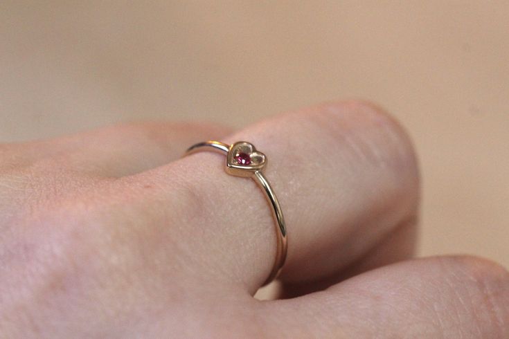 This ring is adorable! It is available in many different stone options. Please specify your gold color upon check out. -Stone is set in a three prong setting and measures 2mm -Round band measures 1.2mm -Handcrafted out of solid 14K yellow, rose or 14K white gold -Inside of the heart has a matte finish while the outer frame has a contrasting high polish shine to make the heart pop. January - Rhodolite Garnet February - Amethyst March - Aquamarine April - White Diamond April - Black Diamond May - Cute Heart Cut Jewelry For Anniversary, Gemstone Heart Ring For May Birthstone, Cute Gold Ring For Anniversary, Cute Gold Rings For Anniversary, Cute Gold Anniversary Rings, Gold Sterling Silver Heart Ring With Gemstone, Dainty Heart-shaped Gemstone Ring, Heart-shaped Gemstone Ring For May Birthstone, Classic 14k Gold Heart-shaped Birthstone Ring