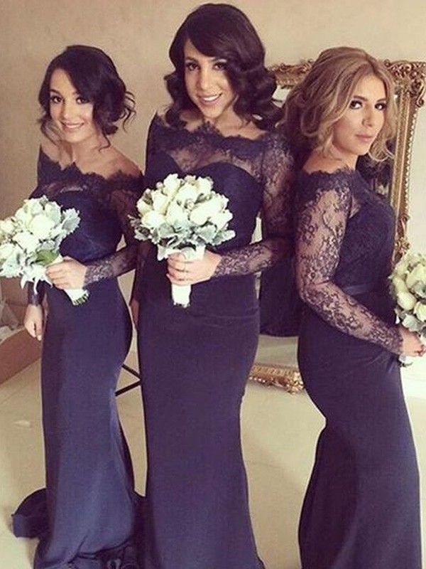 three beautiful women in long dresses posing for the camera with bouquets on their laps