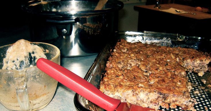 a close up of a pan of food on a table next to an ice cream container