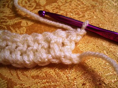 the crochet hook is being used to knit