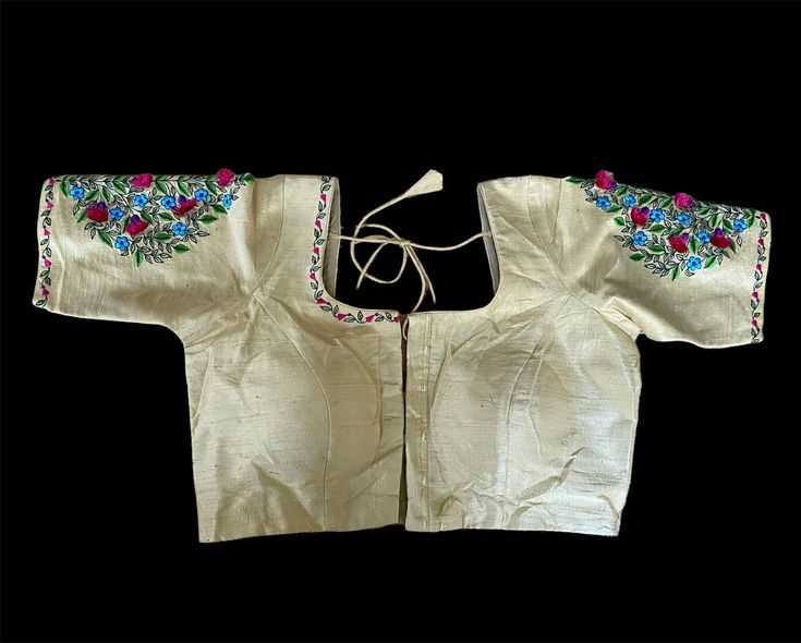 38 size crème embroidery blouse. Comes with 2” margin please allow little variation in colors due to lighting Fitted Raw Silk Blouse With Floral Embroidery, Traditional Silk Embroidered Padded Top, Traditional Cream Choli With Floral Embroidery, Fitted Blouse With Embroidered Border For Festive Occasion, Fitted Festive Blouse With Embroidered Border, Traditional Cream Embroidered Blouse Piece, Traditional Embroidered Cream Blouse Piece, Silk Blouse With Multicolor Embroidery For Wedding, Fitted Blouse With Embroidered Border For Festivals