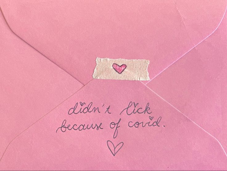 a pink envelope with writing on it and a heart in the middle that says, didn't lick because of cord