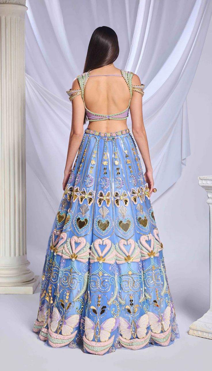 An elegant blue tulle embroidered lehenga adorned with patchwork, special cut acrylics, glass cut beads, pearls, gold chains, sequins and crystals, coupled with a fully embroidered blouse embellished with heart shaped chains, pearls, crystals and glass cut beads. This ensemble is complemented by a matching blue tulle dupatta with an acrylic border and scatters all over for a sophisticated look.From Papa Don’t Preach’s Bring Your Own Fairytale collection. DELIVERY TIMEPlease allow 8-12 weeks for Elegant Lehenga, Once In A Blue Moon, Embroidered Lehenga, Blue Tulle, Indian Designer Wear, Designer Wear, Embroidered Blouse, Blue Moon, Bold Fashion