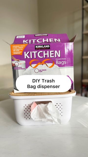 a kitchen trash bag dispenser sitting on top of a white countertop