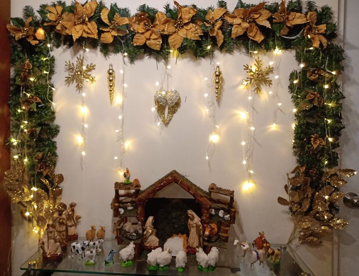 a fireplace decorated for christmas with lights and decorations on the mantel above it is a nativity scene