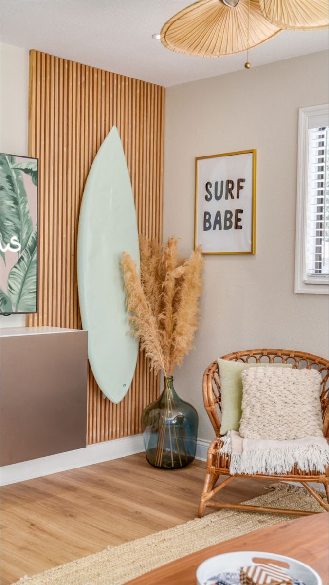 a living room with a surfboard on the wall and two chairs in front of it