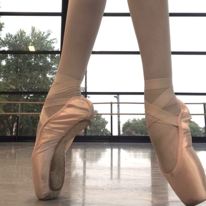 the feet of a ballerina in ballet shoes