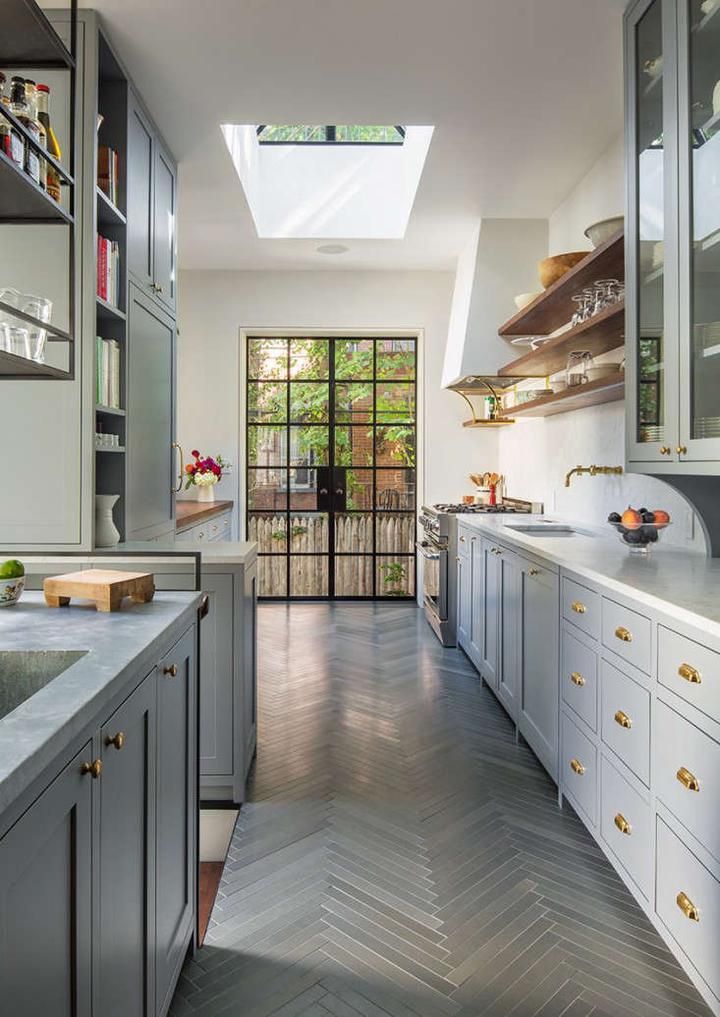 a kitchen with gray cabinets and white counter tops