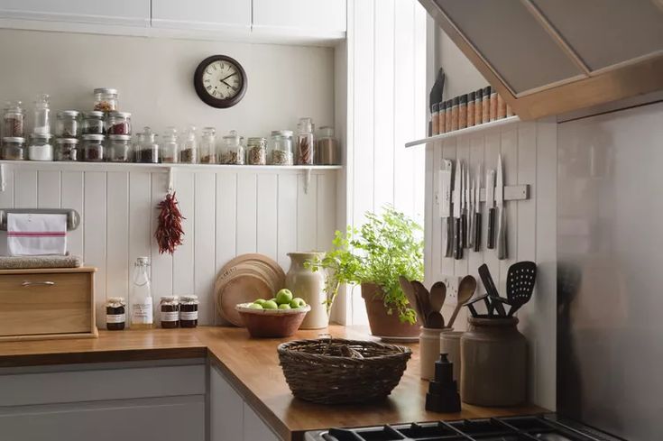 a kitchen with white walls and wooden counters