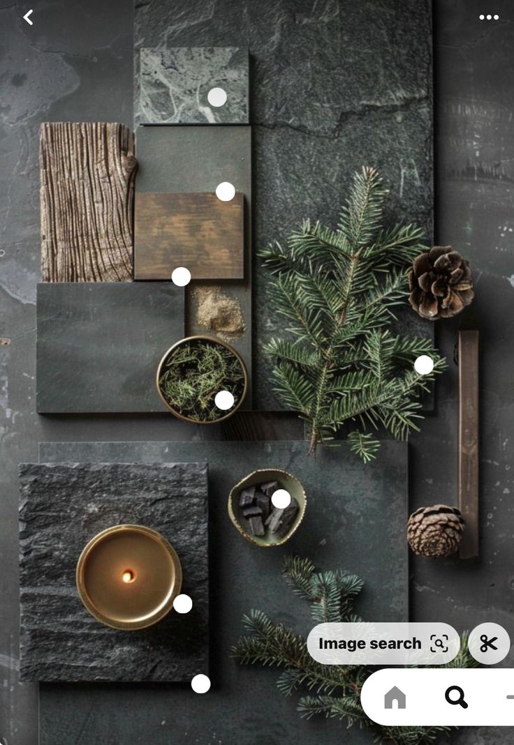 an overhead view of a table with candles, pine cones and other items on it