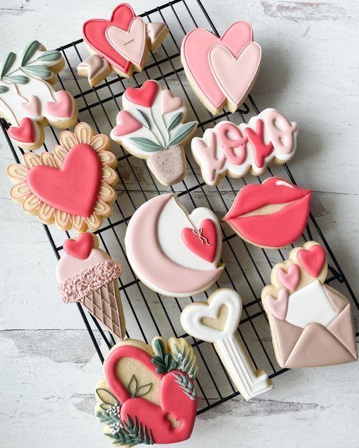 decorated cookies are sitting on a cooling rack