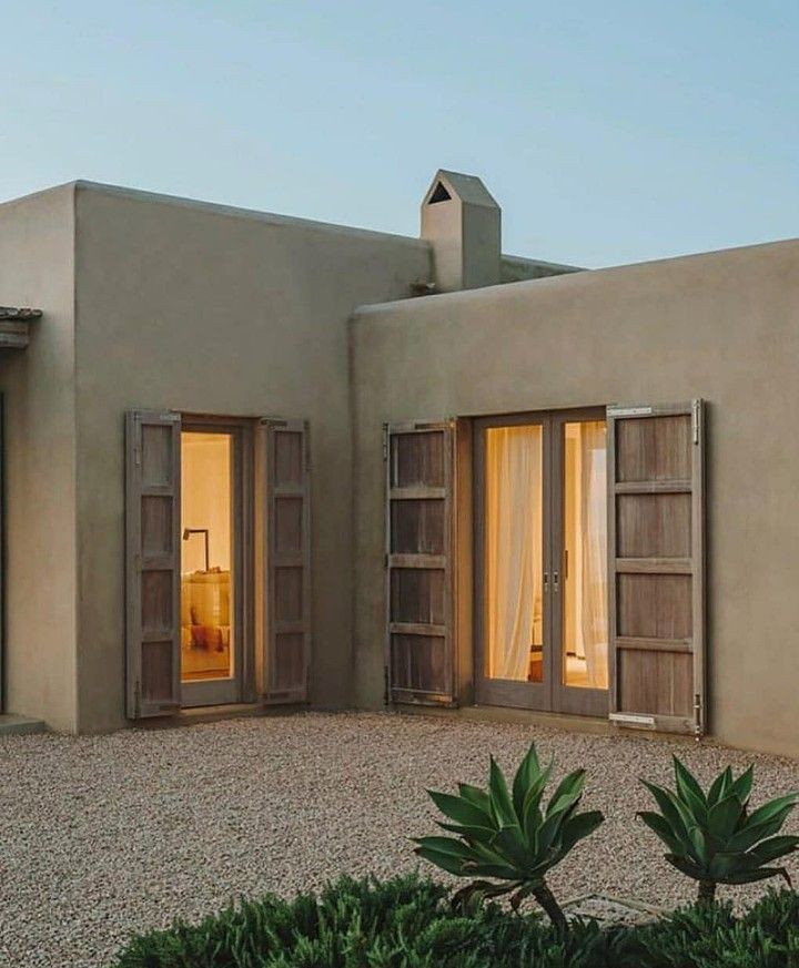 an exterior view of a house with two doors open