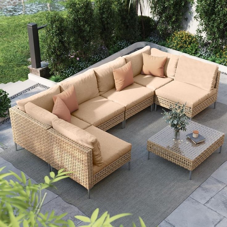 an outdoor living area with couches and tables