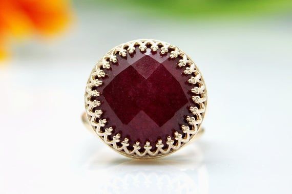 This ring features an amazing Ruby gemstone set in 14k gold filled ring. All sizes available - choose your size before adding the item to your shopping cart. => Gemstone Type - Ruby (Treated) => Gemstone Size - 16mm => Gemstone Cut - Faceted Round => Metal Type - 14k Gold Filled Red Faceted Round Jewelry, Red Round Faceted Jewelry, Unique Round Red Ruby Ring, Elegant Faceted Ruby Ring, Elegant Faceted Round Ruby Ring, Elegant Red Faceted Ring, Faceted Ruby Round Rings, Faceted Ruby Ring As A Gift, Faceted Ruby Ring