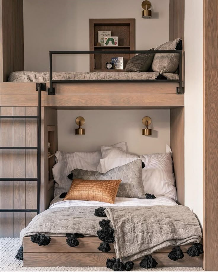 a bunk bed with two sets of pillows on the bottom, and a ladder to the top