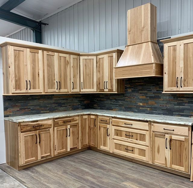 a kitchen with wooden cabinets and tile backsplash in an industrial style home setting