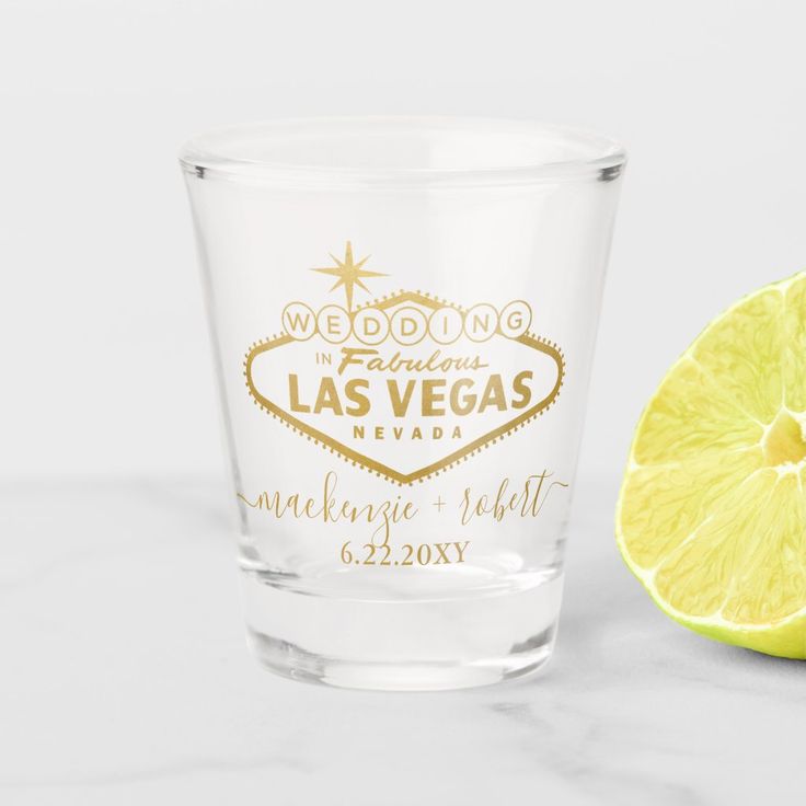 a shot glass with the words save the date printed on it next to a lemon