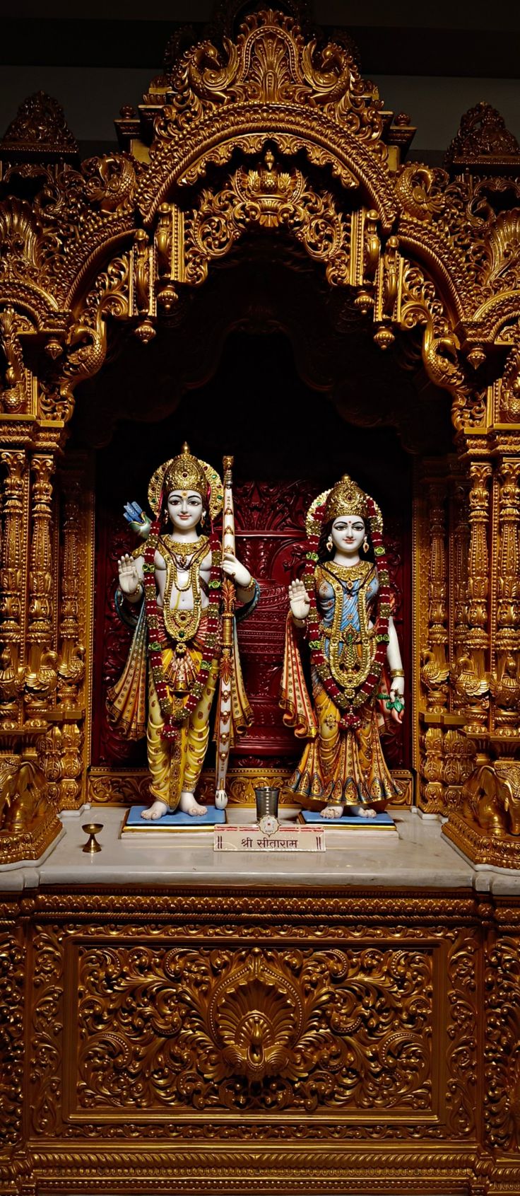 two statues of hindu deities are on display