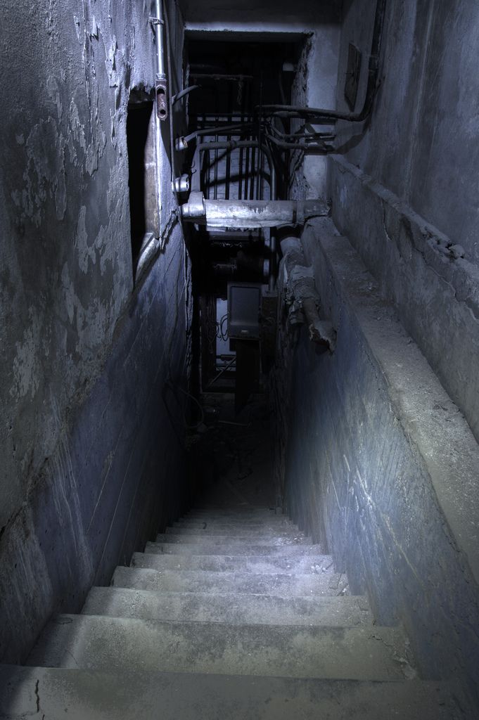 the stairs lead up to an abandoned building