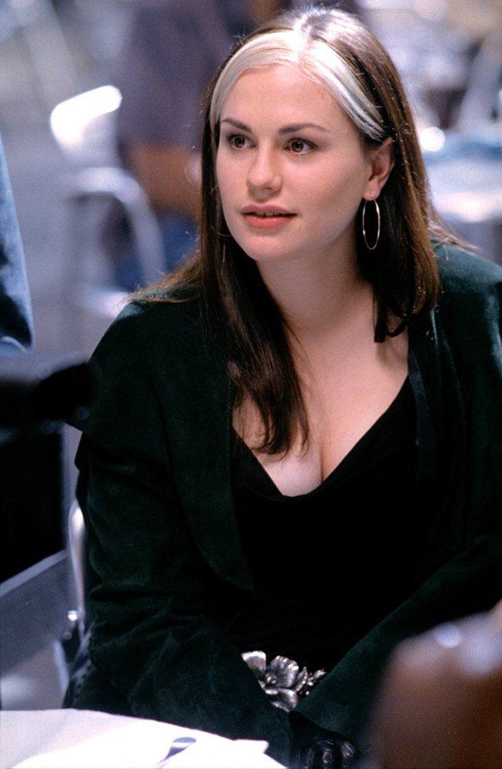 a woman sitting at a table in an office setting