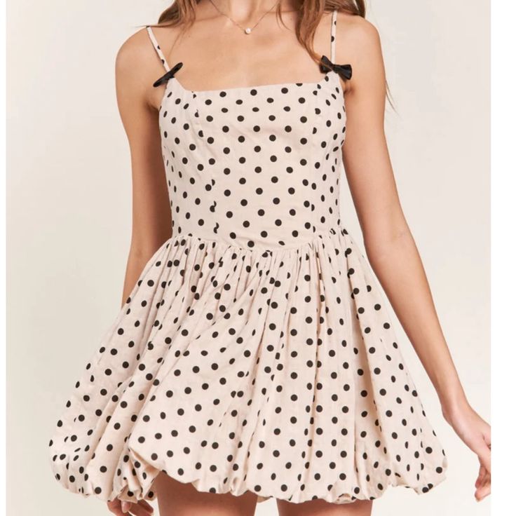 Get Ready To Turn Heads In The Nicolette Polka Dot Mini Dress! This Dress Features A Flattering Square Neckline And A Playful Bubble Hem. The Back Zip Closure Ensures A Secure Fit, While The Bow Detail On The Straps Adds A Charming Touch. With Adjustable Straps And All Over Polka Dot Detailing, This Dress Is Both Versatile And Stylish. Chic Polka Dot Mini Dress For Summer, Polka Dot Mini Sundress For Summer, Flirty Polka Dot Mini Dress For Summer, Polka Dot Mini Dress For Beach, Polka Dot Summer Mini Dress, Spring Polka Dot Mini Dress, Polka Dot Mini Dress For Summer, Polka Dot A-line Mini Dress For Summer, Polka Dot Mini Dress For The Beach