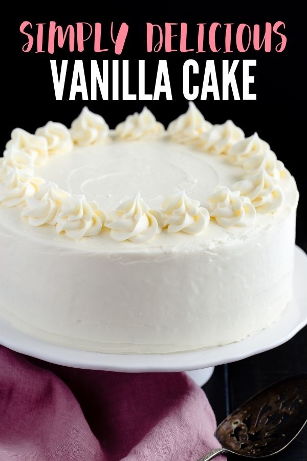 a white cake sitting on top of a plate next to a pink napkin and spoon